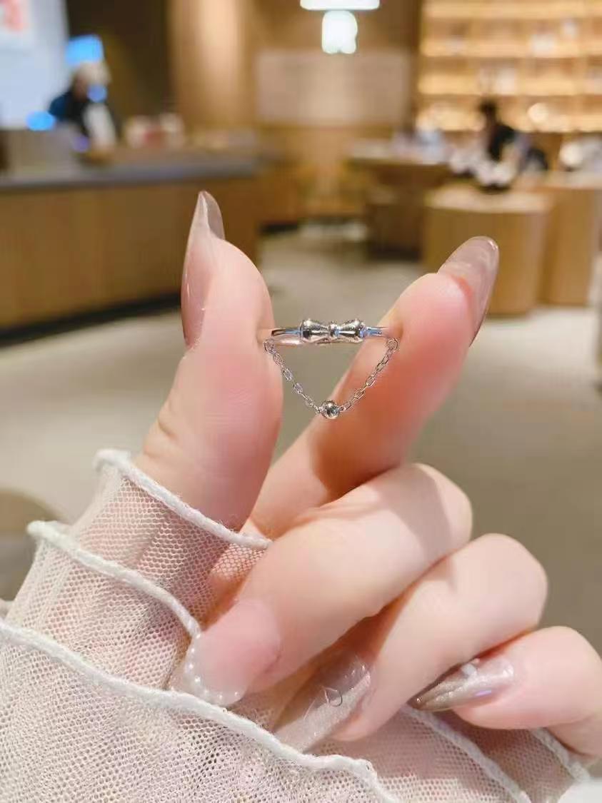 Dancing Silhouette Ring | Hand-Sculpted Bow & Dangling Bead | 925 Sterling Silver Heirloom
