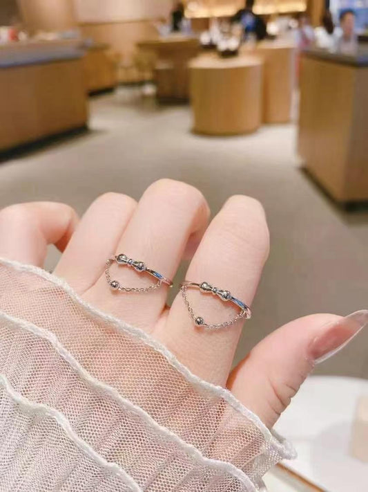 Dancing Silhouette Ring | Hand-Sculpted Bow & Dangling Bead | 925 Sterling Silver Heirloom